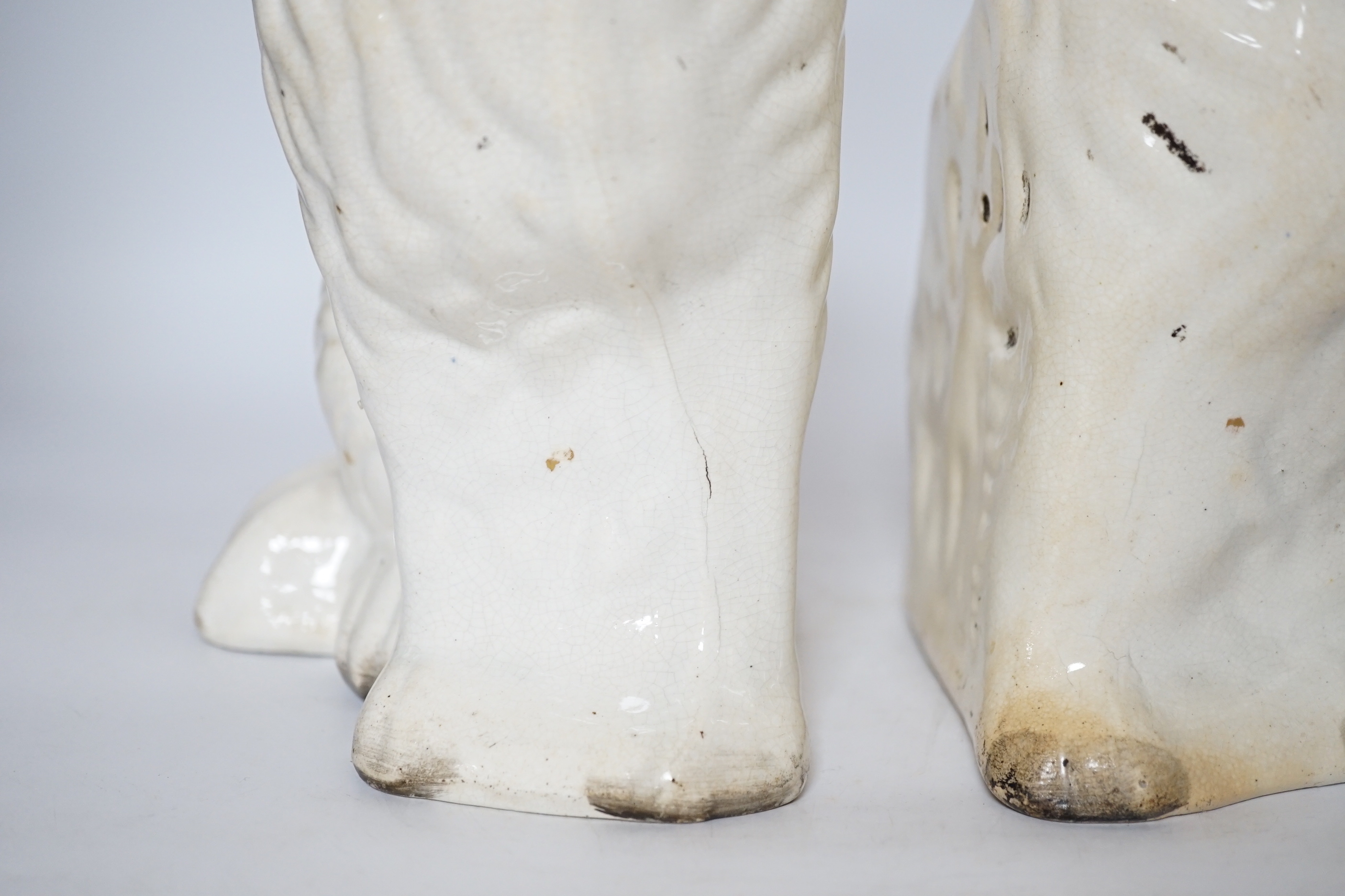 A pair of Staffordshire pottery dogs, 25cm high
